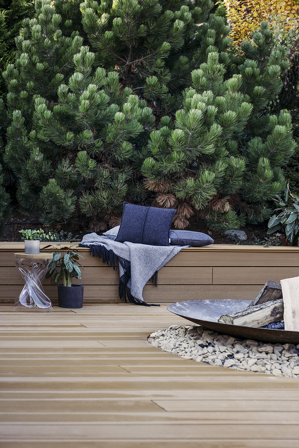 Composite WPC terrace with a garden fire pit and a relaxation area