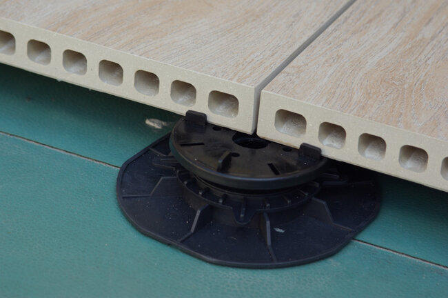 Installation of ceramic pavers on an adjustable terrace pedestal