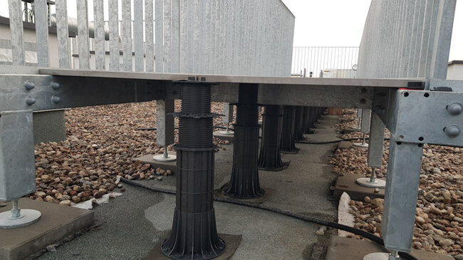 High adjustable terrace pedestals under a raised deck floor