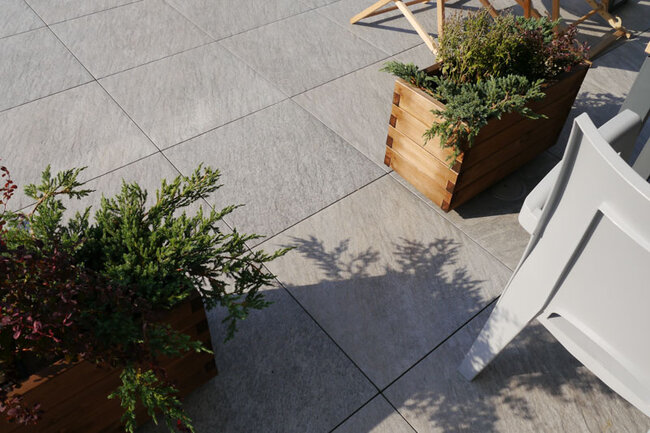 Light greige pavers on a raised deck terrace with plant pots