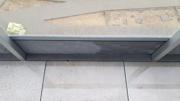 photo of one way of finishing a floating terrace when using a glass barrier