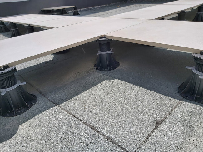 Photo showing a fixed-height support pad for pavers