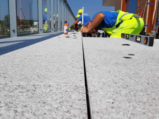 Installation of terrace pavers on a raised deck terrace
