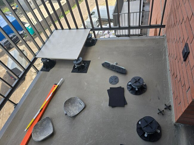 The first laid paver on the balcony after leveling on the standard adjustable pedestal