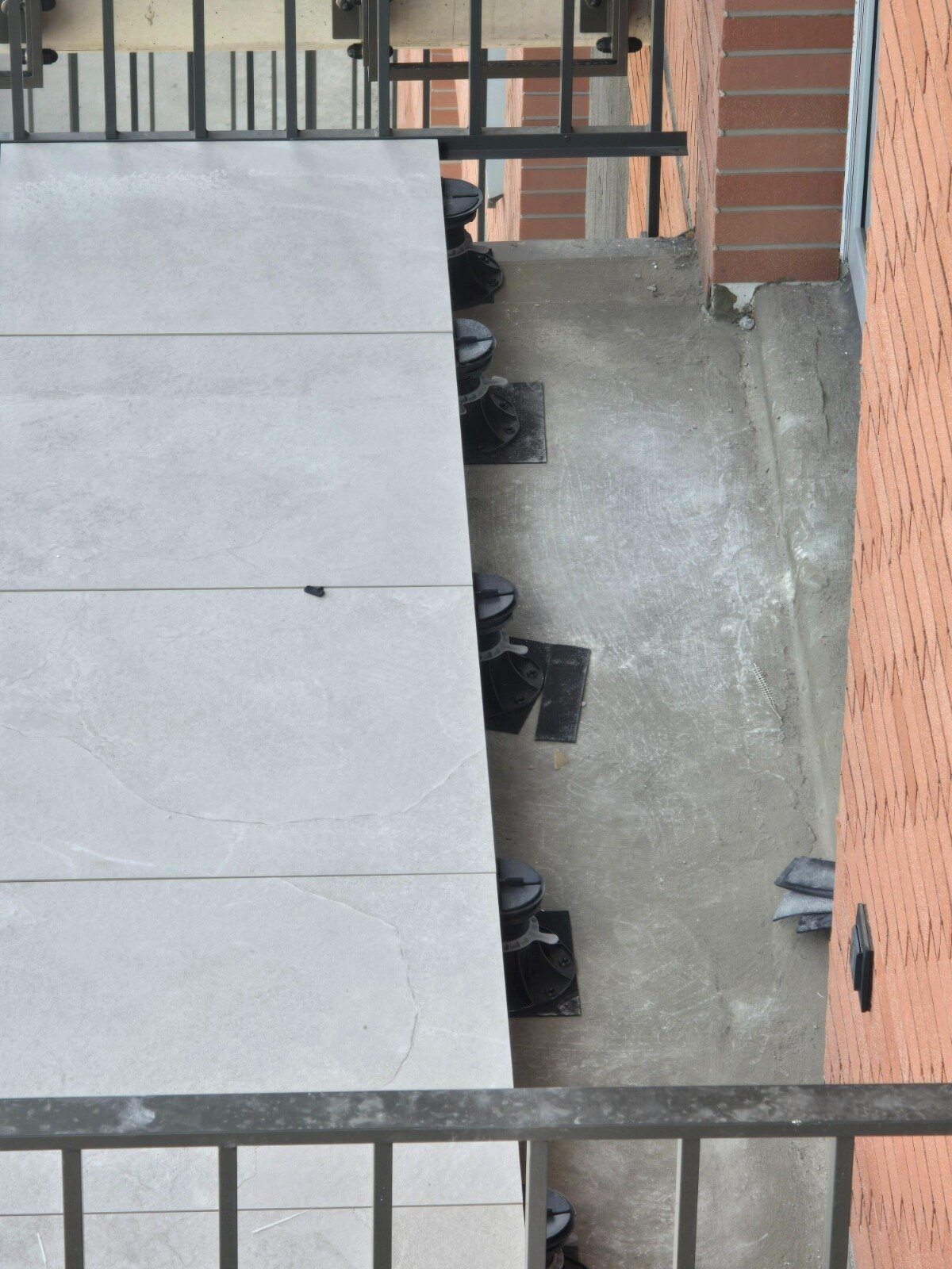 Pavers laid on adjustable pedestals on a balcony in a multi-family building