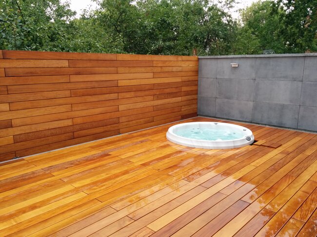 Jacuzzi on a raised deck terrace with wooden boards