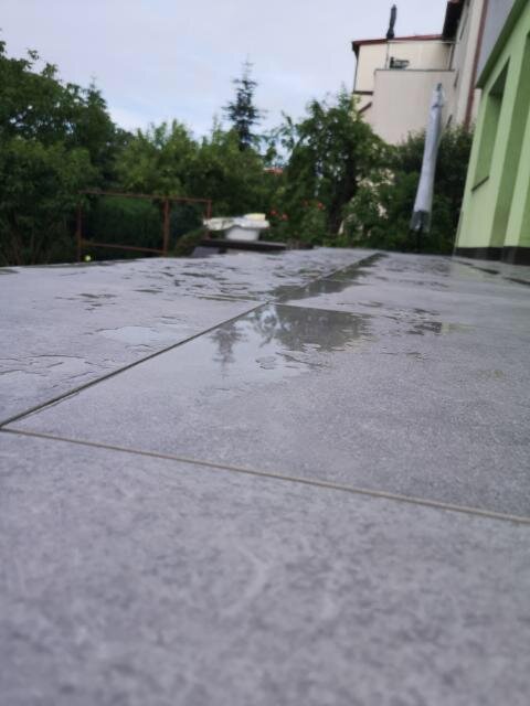 Standing water on pavers on the terrace