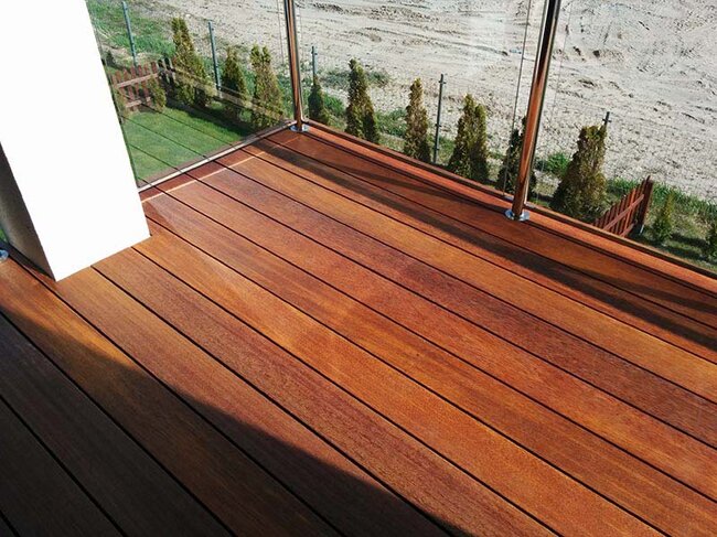 Balcony finished with exotic wood decking and a glass balustrade.