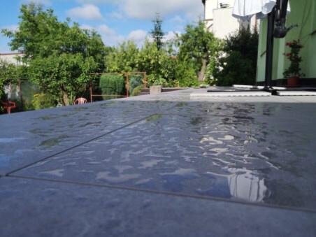 Wet ceramic pavers on an external terrace