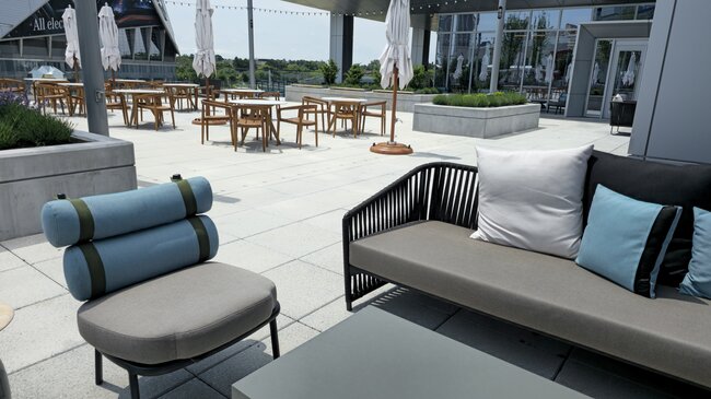Leisure zone with garden furniture on a large raised deck terrace with pavers
