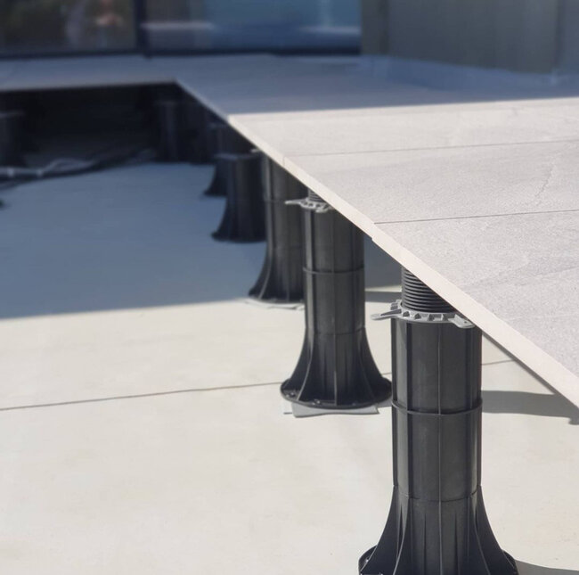 High adjustable pedestals for ceramic tiles on a raised deck terrace