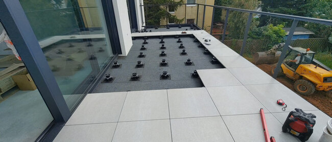 Laying gres tiles on terrace pedestals