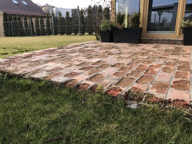 Damaged glued terrace made of bricks on the ground
