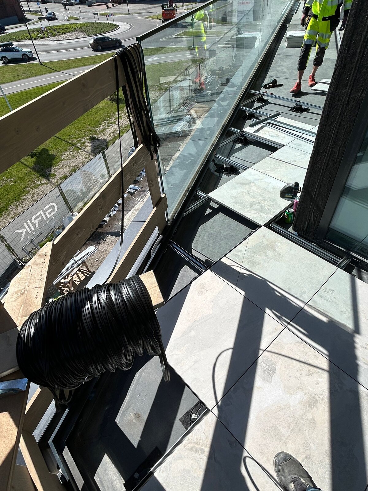Balcony raised floor system under construction with outdoor porcelain tiles and adjustable pedestals.