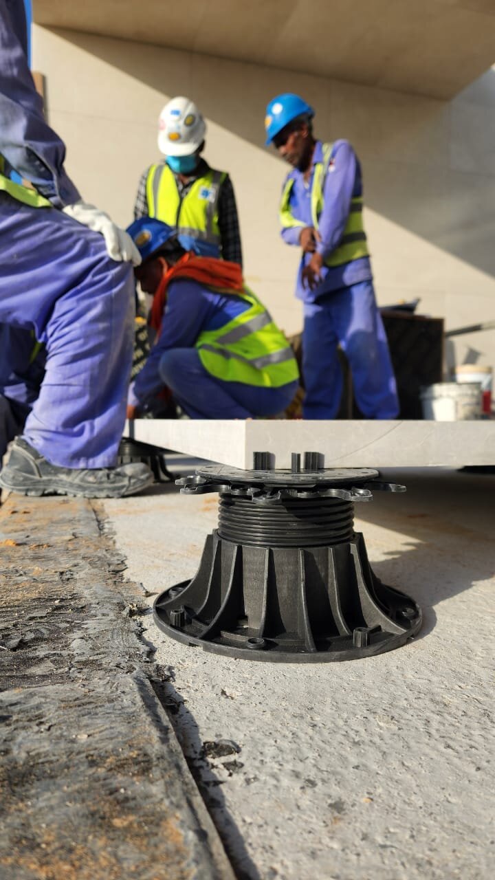 Adjustable plastic pedestal support system for outdoor raised paving slabs.