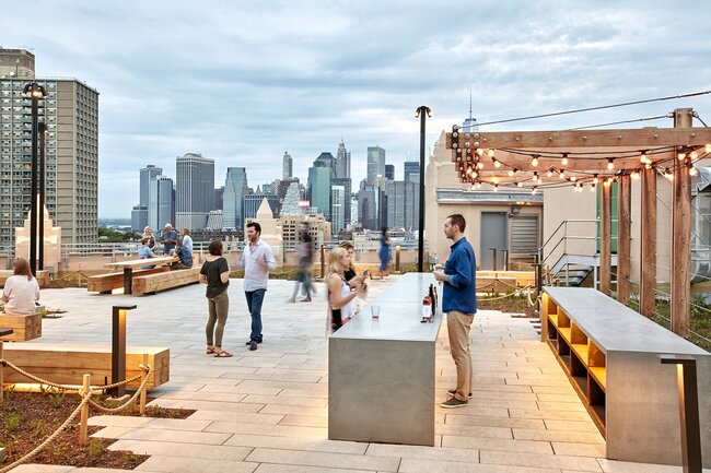 Modern rooftop terrace deck with elevated stone pavers supported by adjustable pedestals.