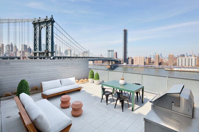 Rooftop lounge deck with raised paver flooring built on adjustable pedestals.