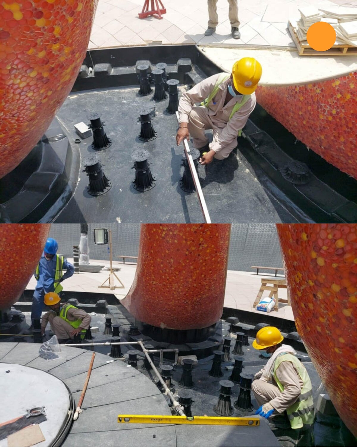 Workers using spirit levels to align and install adjustable pedestals around an outdoor fountain structure.